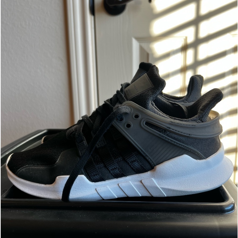 Black Adidas EQT size 7Y which is an 8.5 in Women slightly worn
